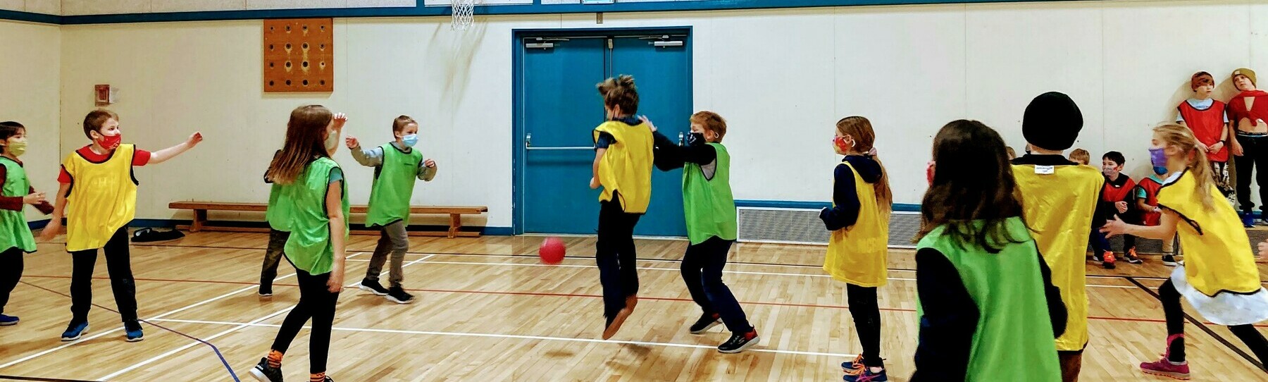 Students playing handball in the gym